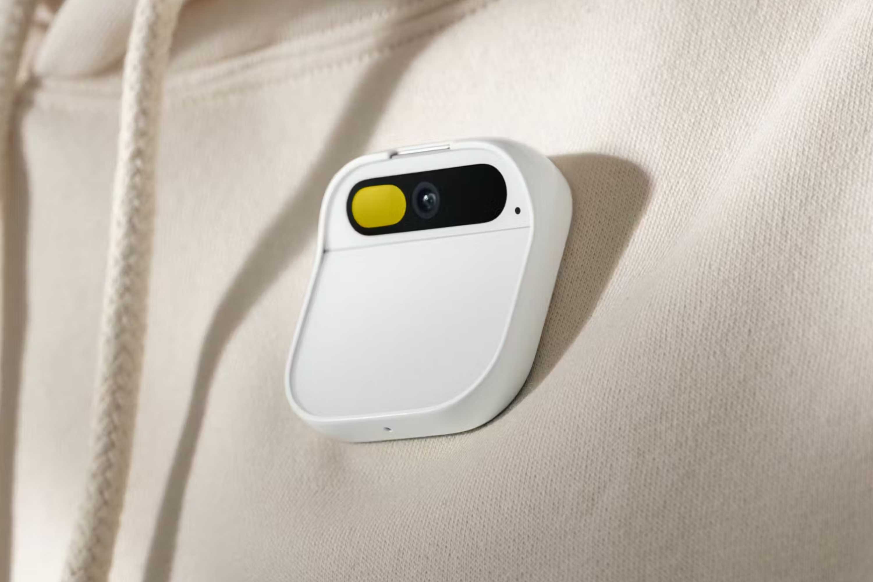 Humane's AI Pin attached to a sweatshirt.