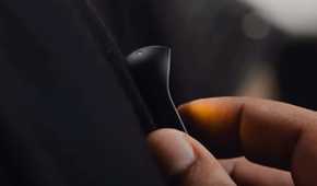 A person controlling the Humane AI Pin with touch.