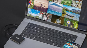 Crucial X9 Portable SSD connected to a MacBook with an iPhone on the side