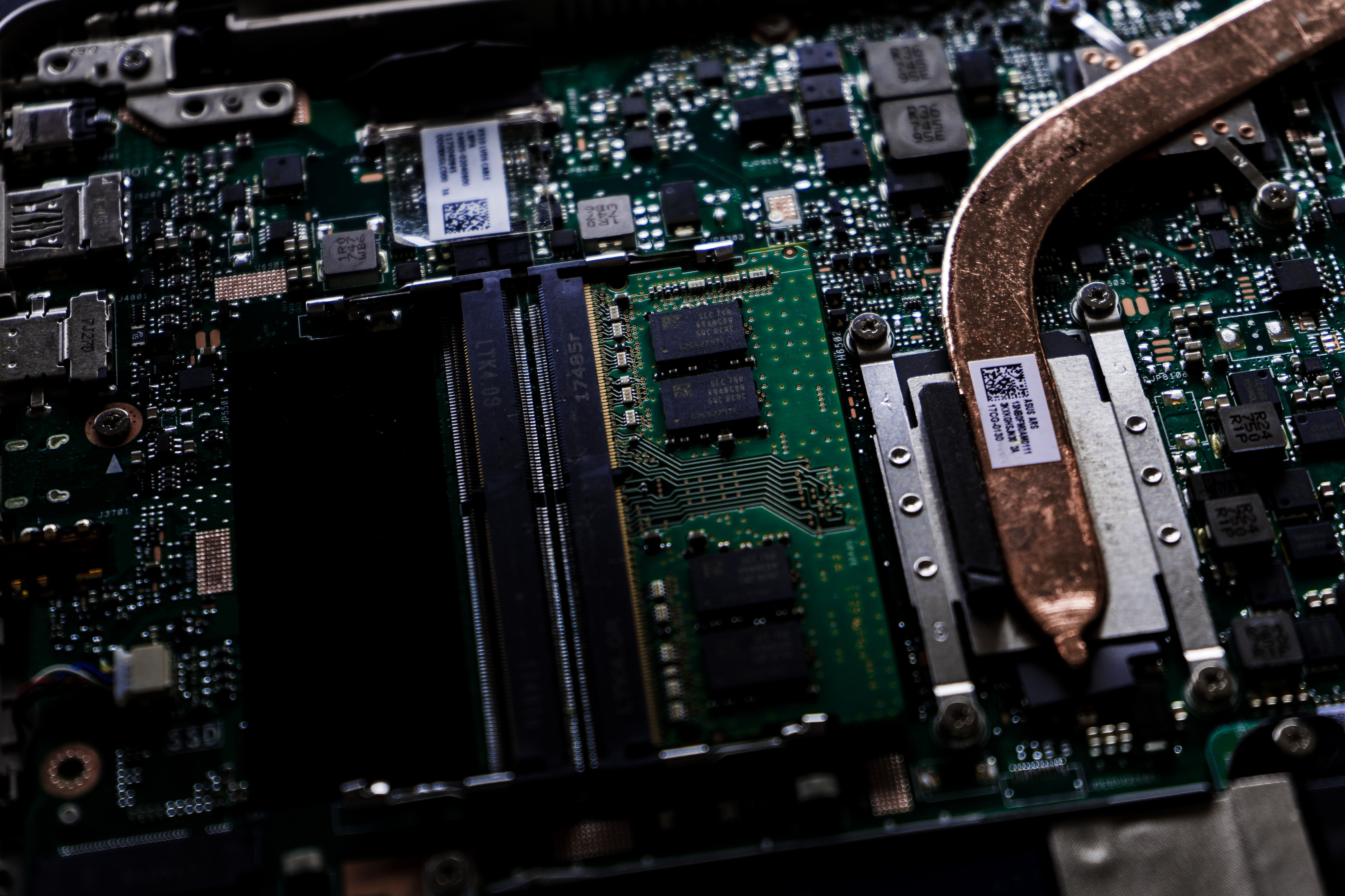A close up image of a motherboard with a CPU heatsink extending offscreen, the rest of the motherboard is blurred in the background