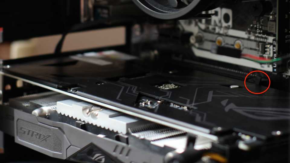 GPU installed in a PC case with the PCIe mounting bracket highlighted