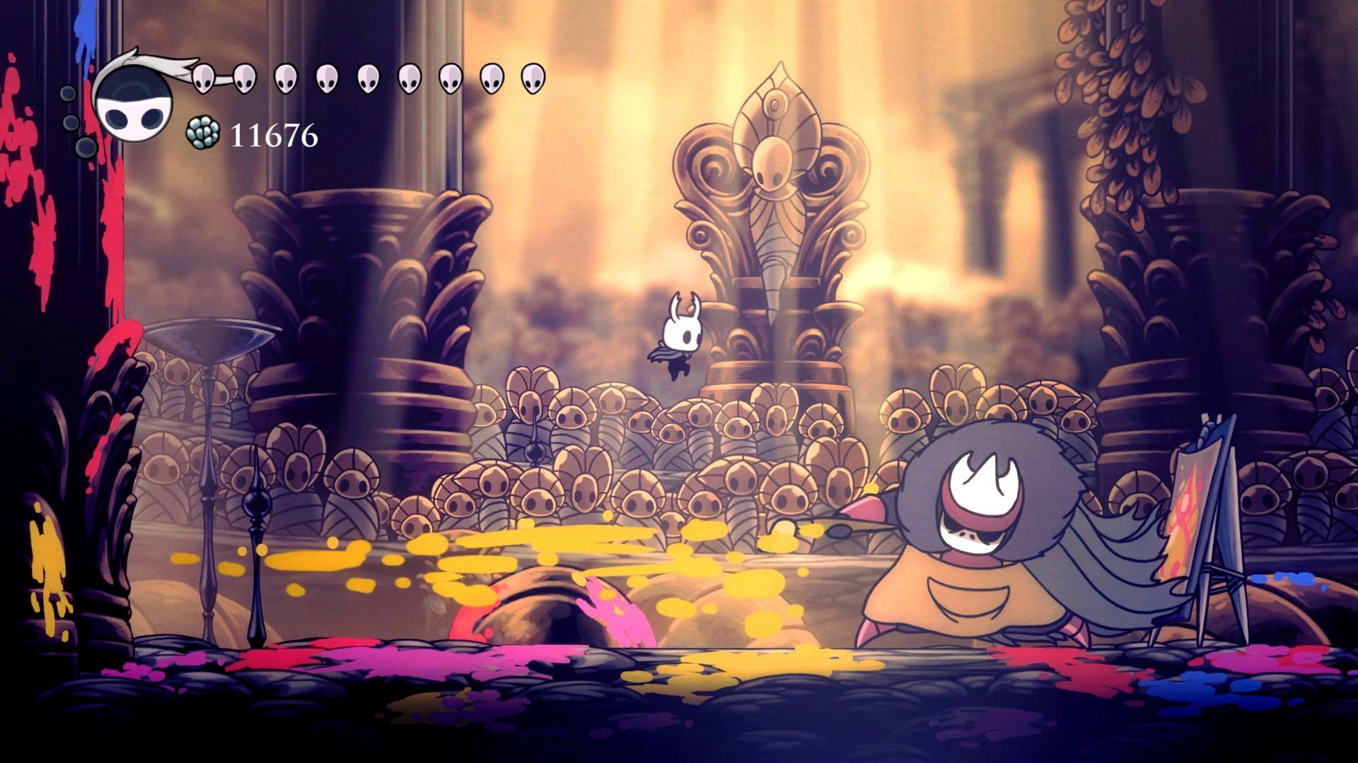 A tiny character jumping around a large creature from the game Hollow Knight.