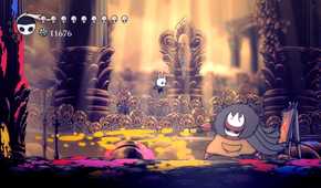 A tiny character jumping around a large creature from the game Hollow Knight.