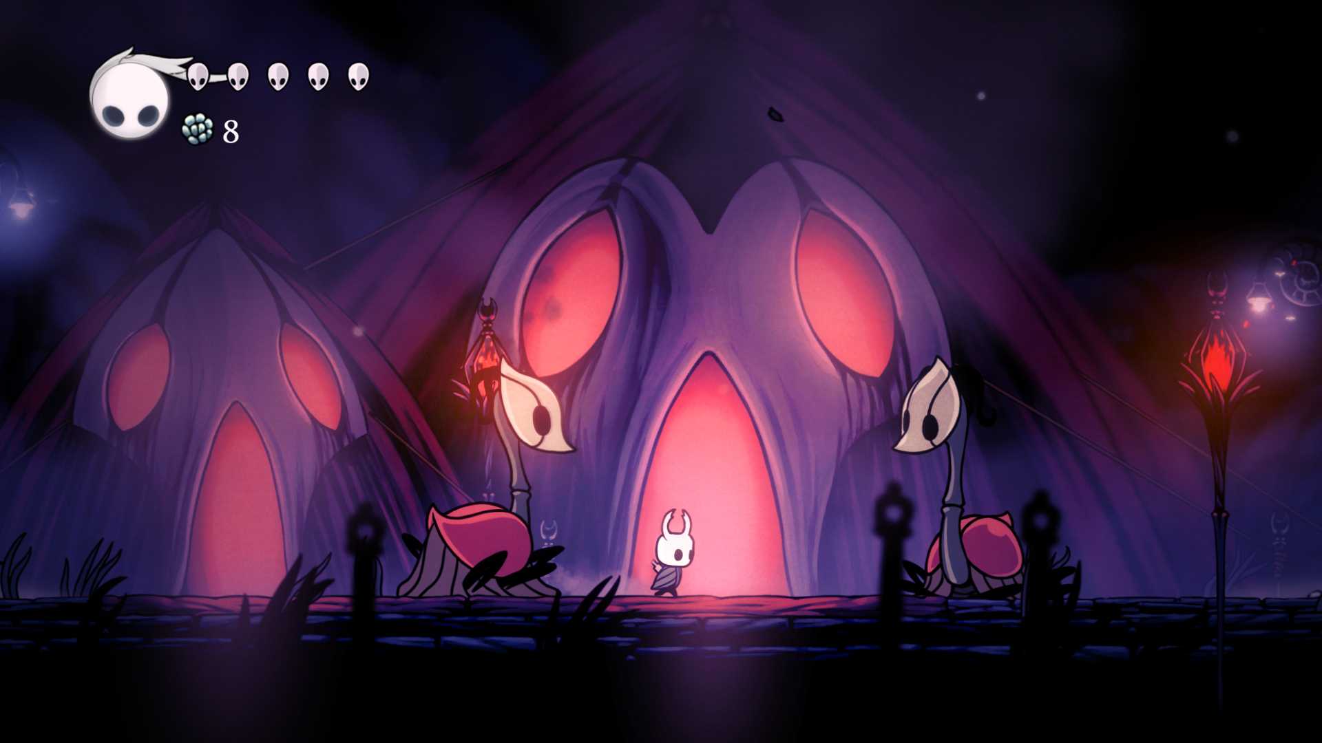 A character standing between two creatures from the game Hollow Knight.