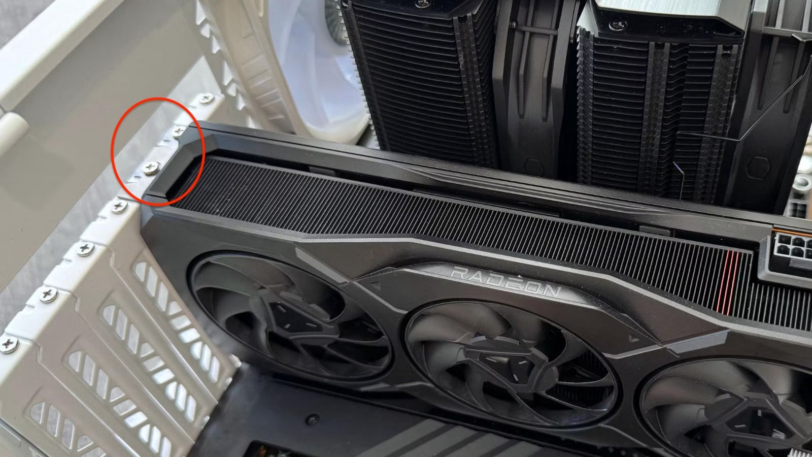 AMD Radeon GPU installed in case with mounting screws highlighted