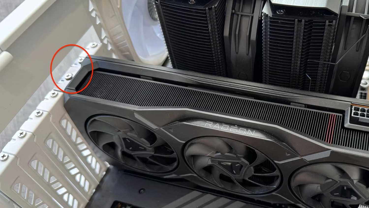 AMD Radeon GPU installed in case with mounting screws highlighted