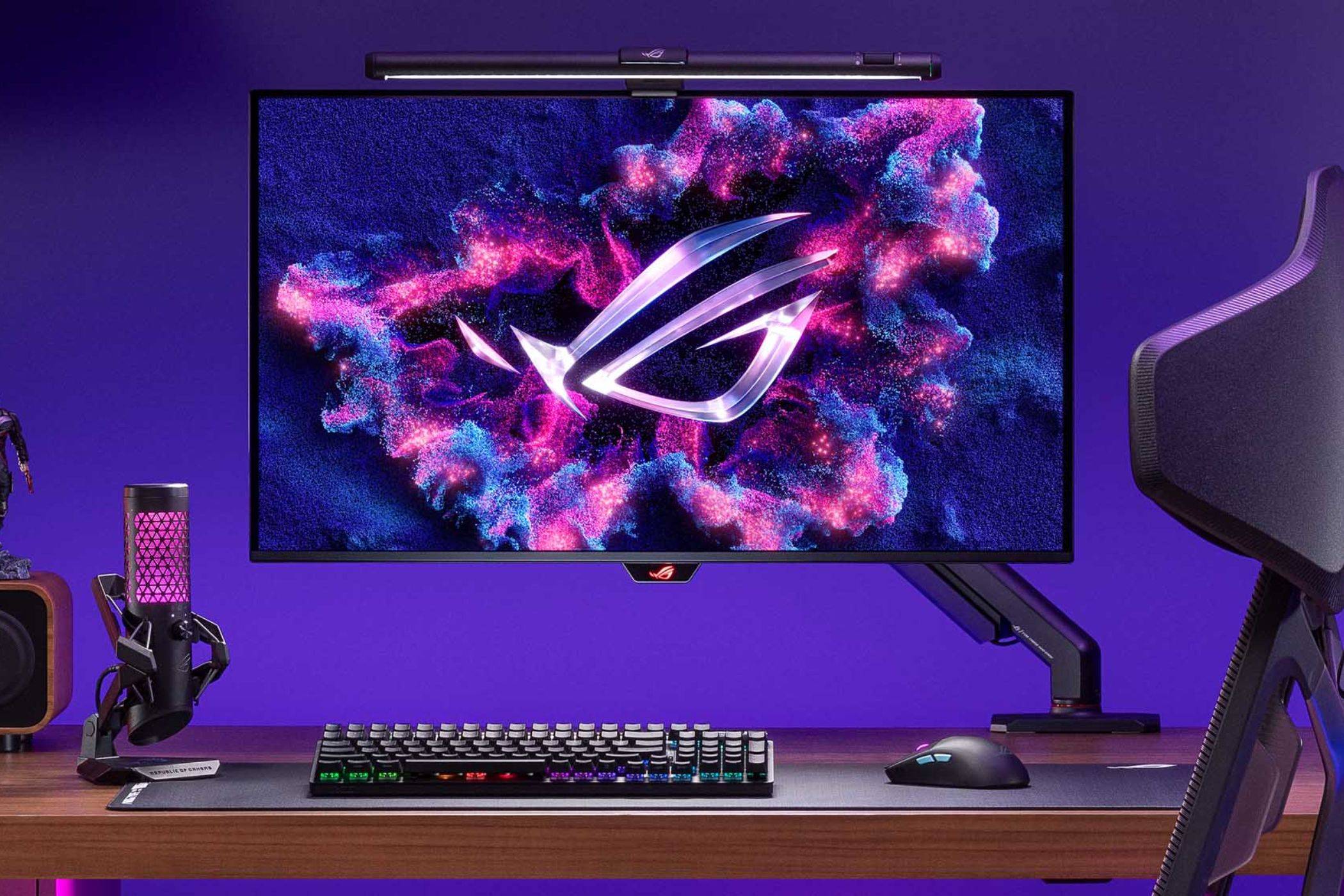 An image showing the ASUS ROG Swift PG32UCDM monitor mounted on a stand that's attached to a gaming desk.