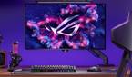 An image showing the ASUS ROG Swift PG32UCDM monitor mounted on a stand that's attached to a gaming desk.