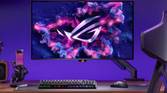 An image showing the ASUS ROG Swift PG32UCDM monitor mounted on a stand that's attached to a gaming desk.