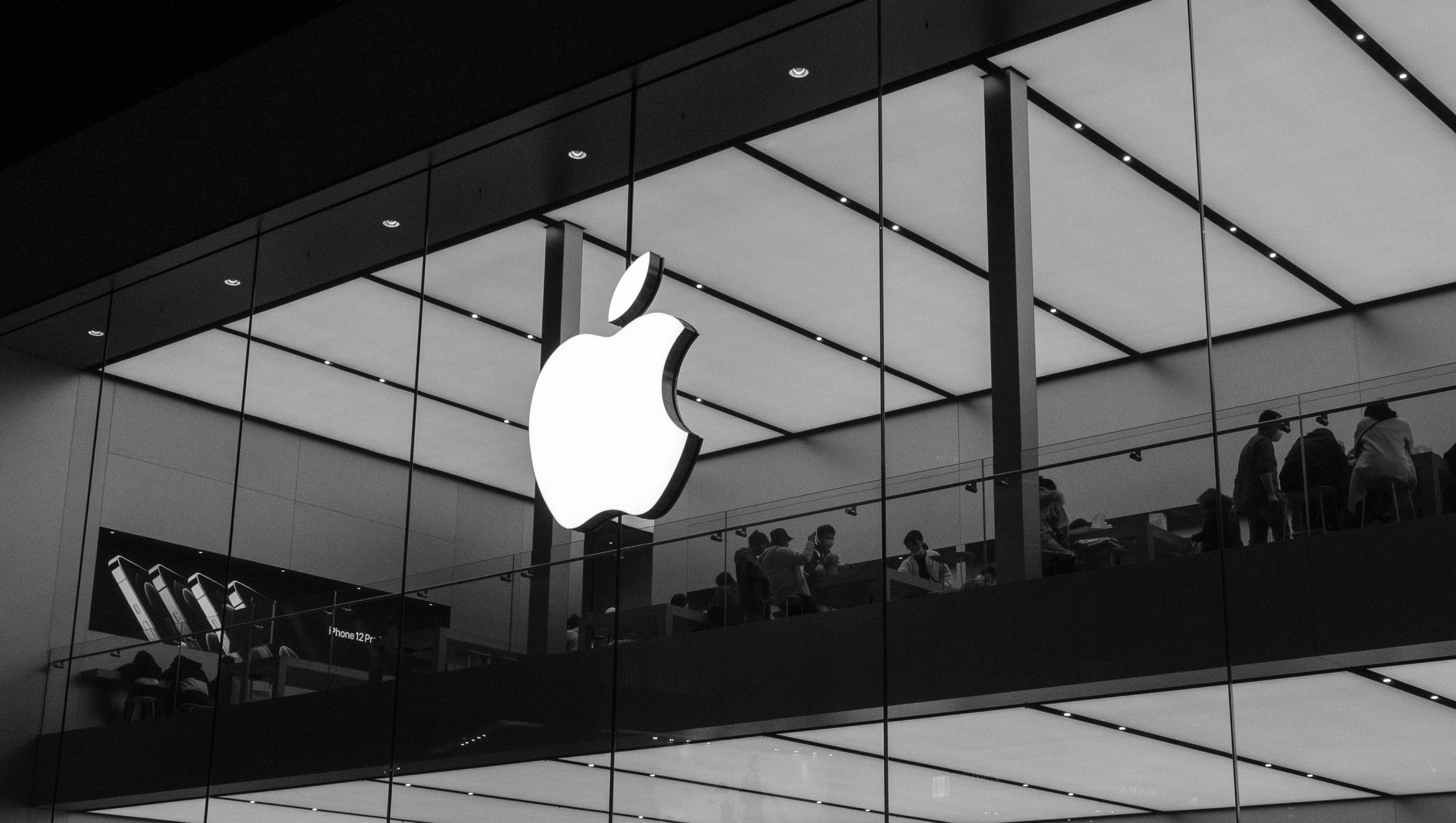 An image of the Apple logo on the outside of an Apple Store.