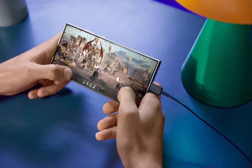 An image showing a person playing a game on a Galaxy S24 Ultra while it's connected to a charger.