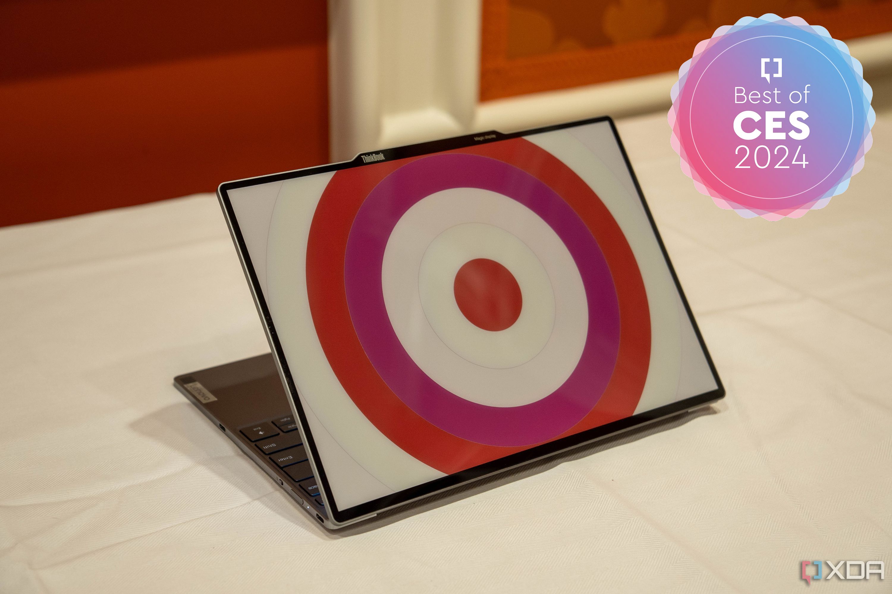 Angled view of the Lenovo ThinkBook 13x Gen 4 SPE showing a circular pattern in white and pink on the lid