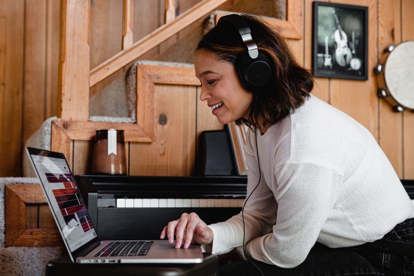 Person using a laptop wearing headphones