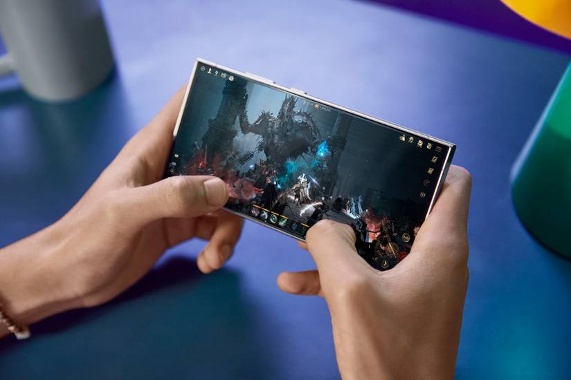 A person holding a Samsung Galaxy S24 Ultra while gaming.