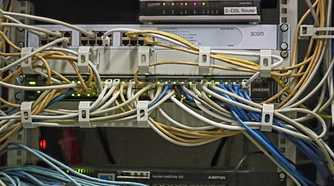 Image of switches and server with ethernet cables running