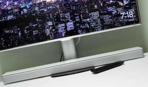 Soundbar under a PC monitor on a desk