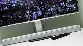 Soundbar under a PC monitor on a desk