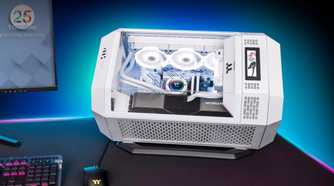 An image showing the Thermaltake The Tower 300 PC case resting on a table next to a monitor.