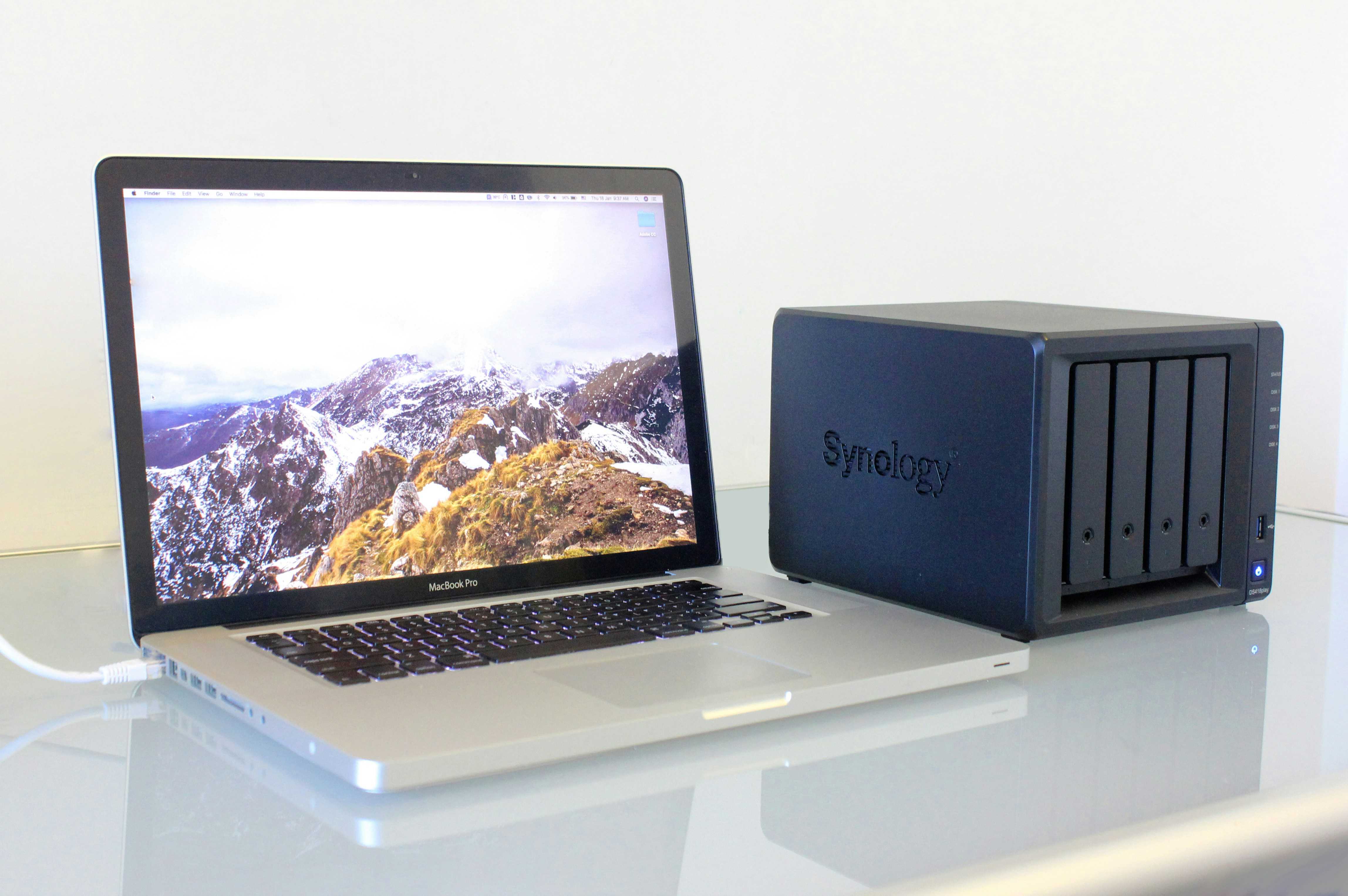 Photo of a MacBook Pro connected to a Synology NAS.