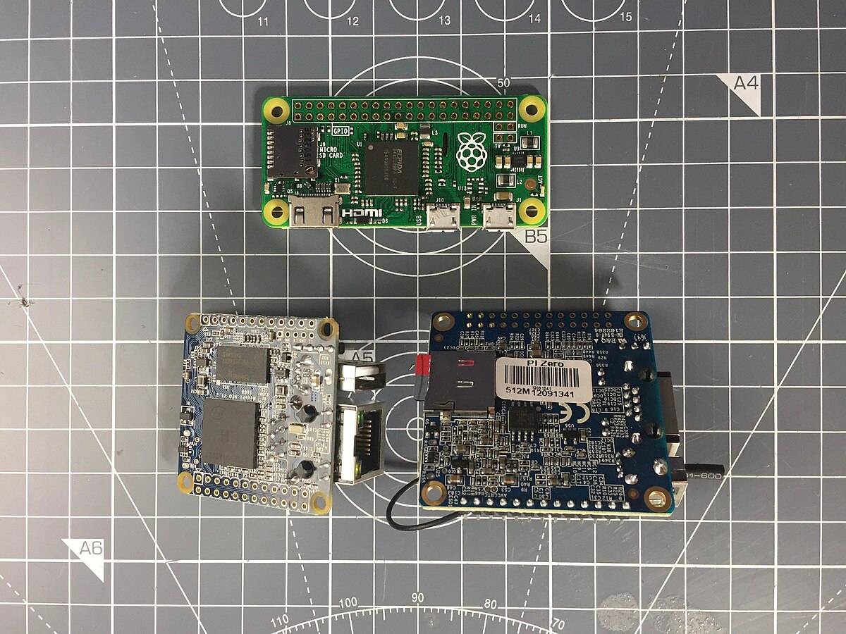 A NanoPi NEO, Orange Pi Zero, and a Raspberry Pi Zero placed next to each other