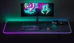A monitor, SteelSeries keyboard, mouse, and headset on top of SteelSeries QCK Prism RGB mousepad