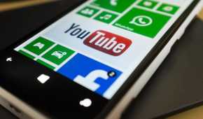 Close-up of a Windows phone with the YouTube app pinned to the Start screen