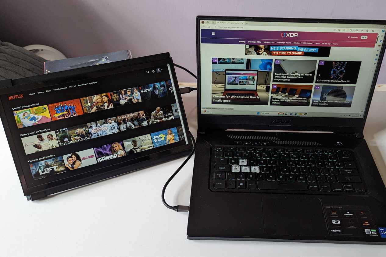 portable monitor showing netflix while laptop shows XDA website