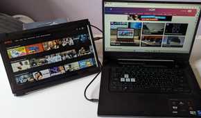 portable monitor showing netflix while laptop shows XDA website