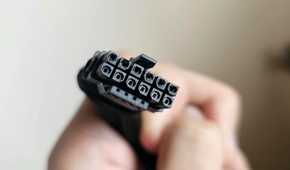 An image showing a person holding a burnt 12VHPWR connector cable in their hand.