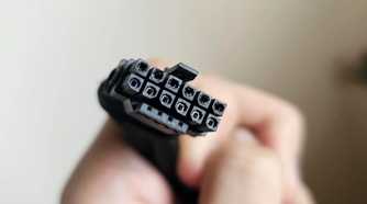 An image showing a person holding a burnt 12VHPWR connector cable in their hand.