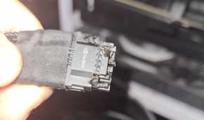 An image showing a person holding a burnt 12VHPWR connector in their hand.