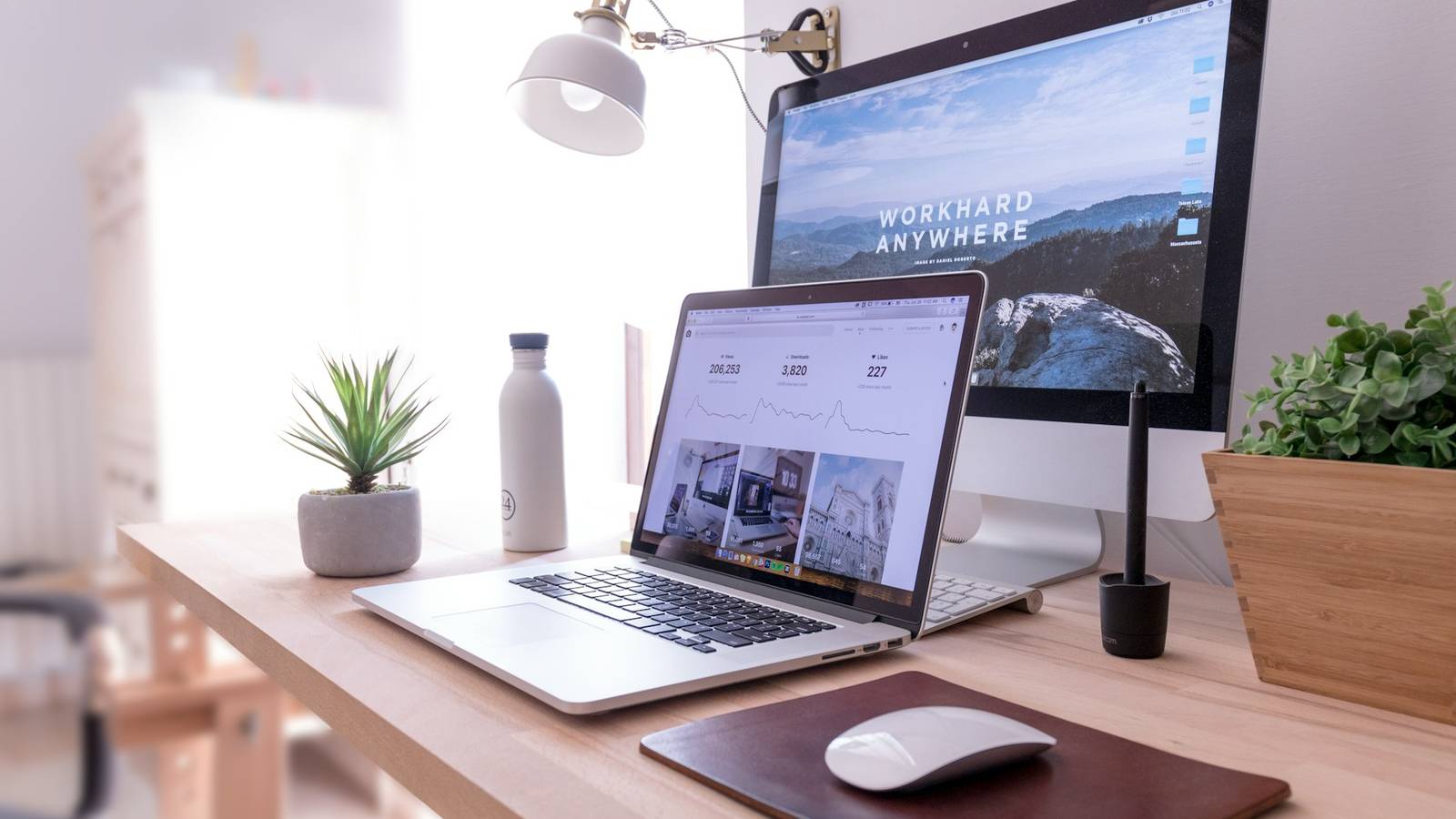 Laptop in front of a computer monitor