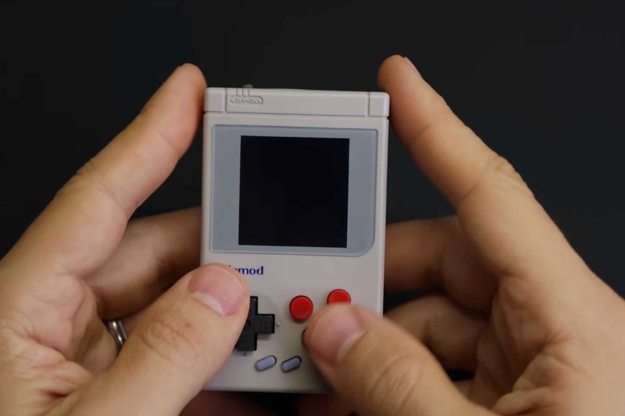 An image showing a person holding a DIY Gem Boy Zero handheld game machine.