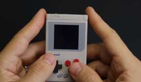 An image showing a person holding a DIY Gem Boy Zero handheld game machine.