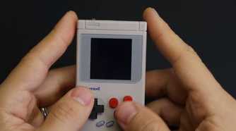 An image showing a person holding a DIY Gem Boy Zero handheld game machine.