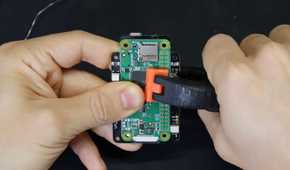 An image showing a person attaching a Raspberry Pi module to a PCB.