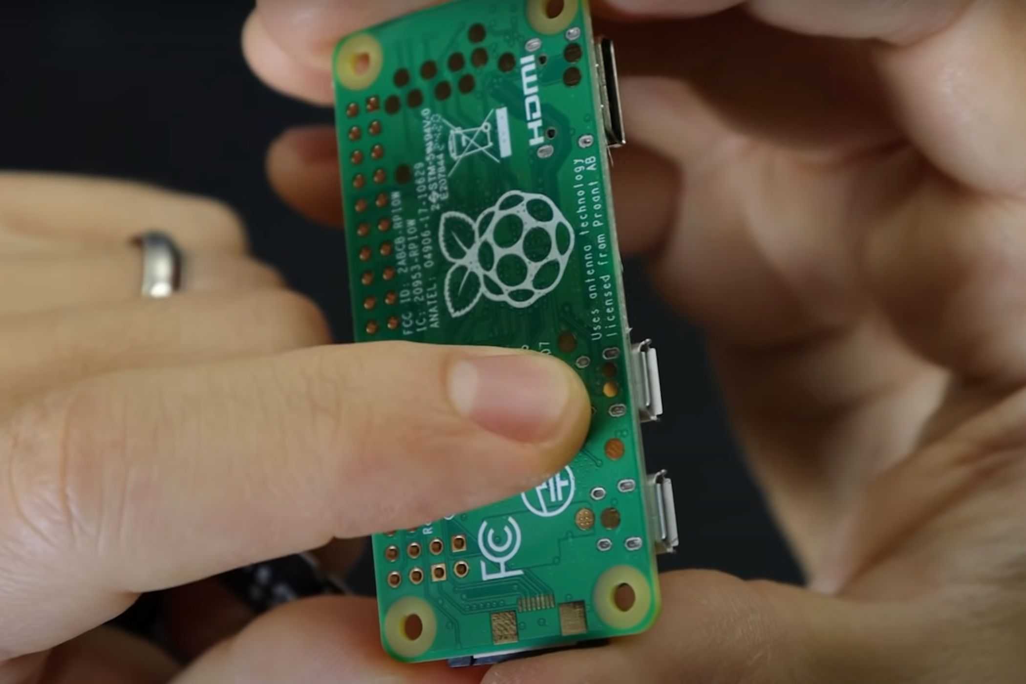 An image showing a person pointing the ports on the Raspberry Pi.