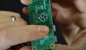 An image showing a person pointing the ports on the Raspberry Pi.