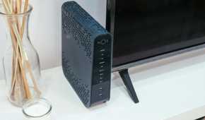 A router next to a television and incense sticks