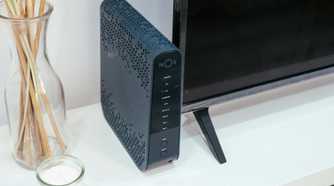 A router next to a television and incense sticks