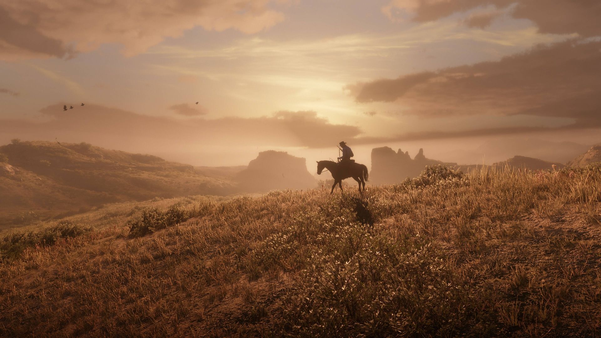A man riding a horse into the sunset