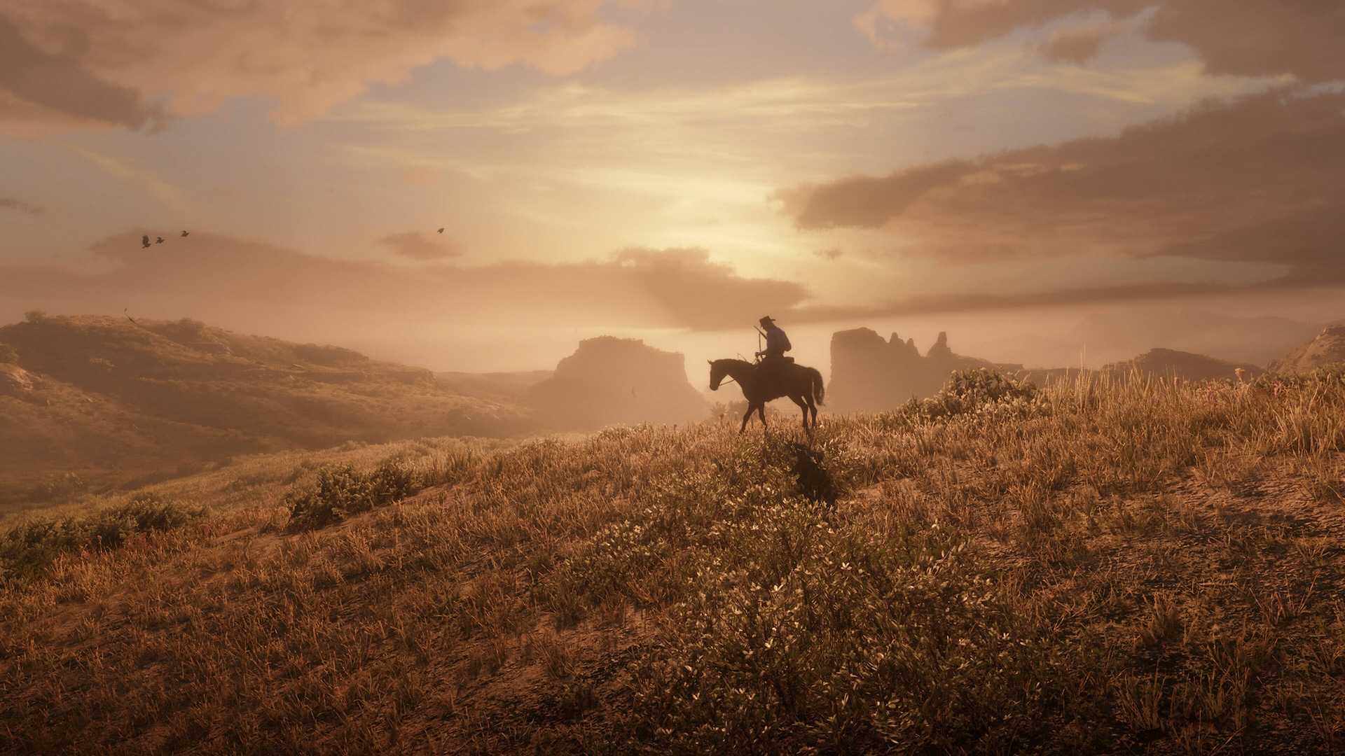 A man riding a horse into the sunset