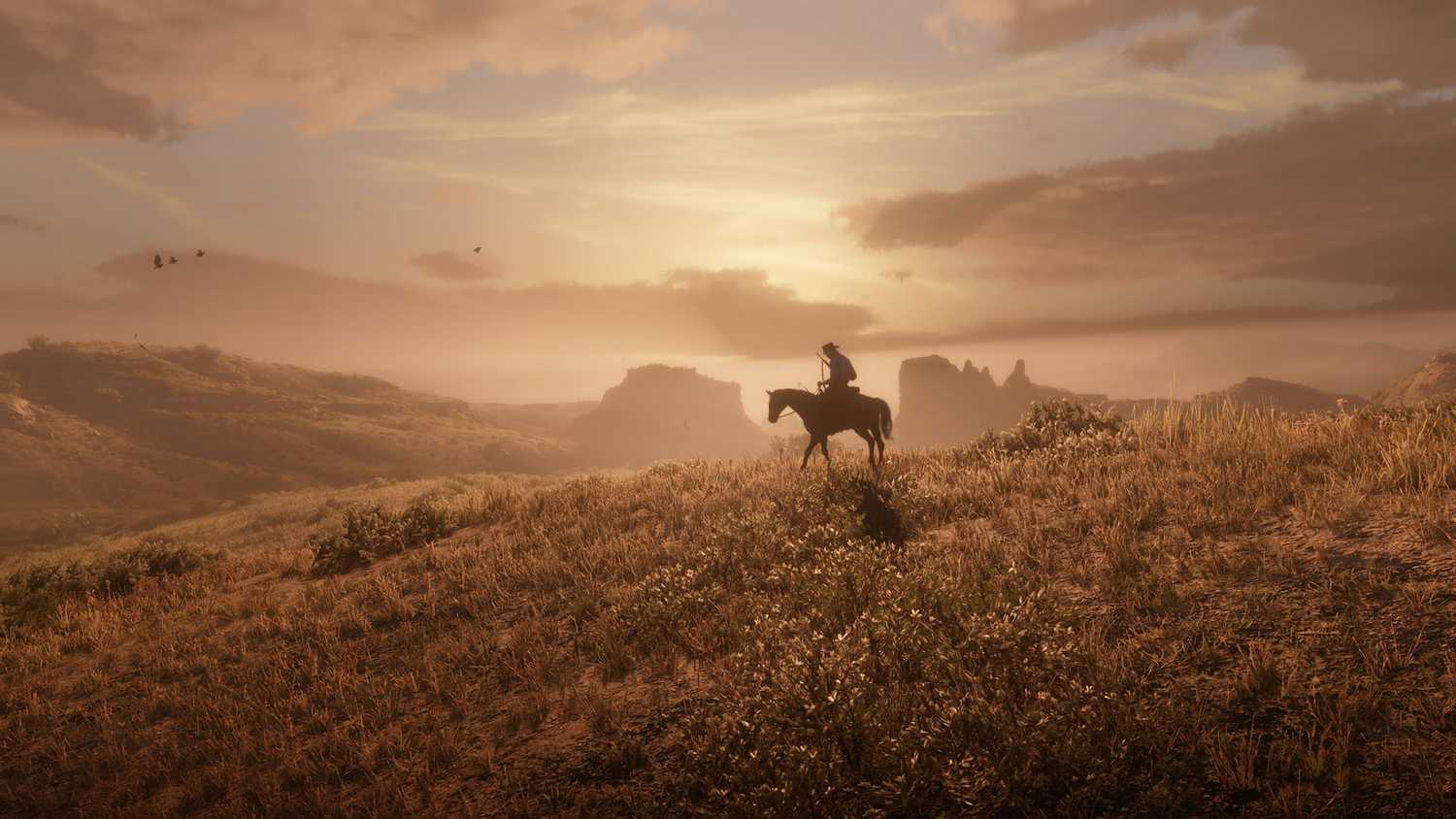 A man riding a horse into the sunset