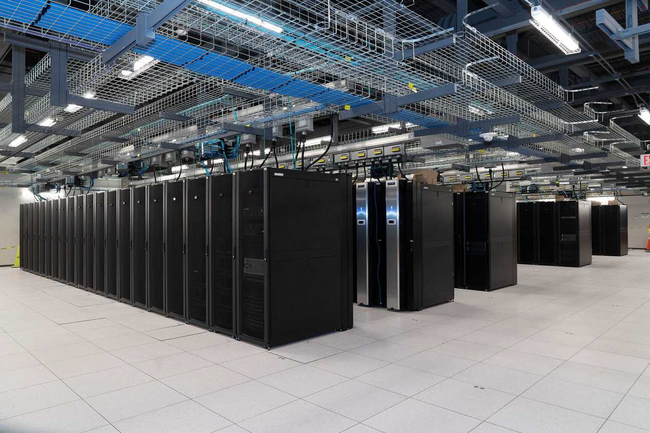 Wide shot of a scientific facility data center showing multiple racks