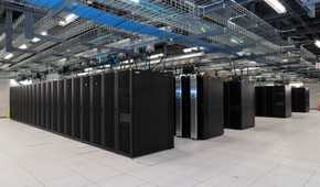 Wide shot of a scientific facility data center showing multiple racks