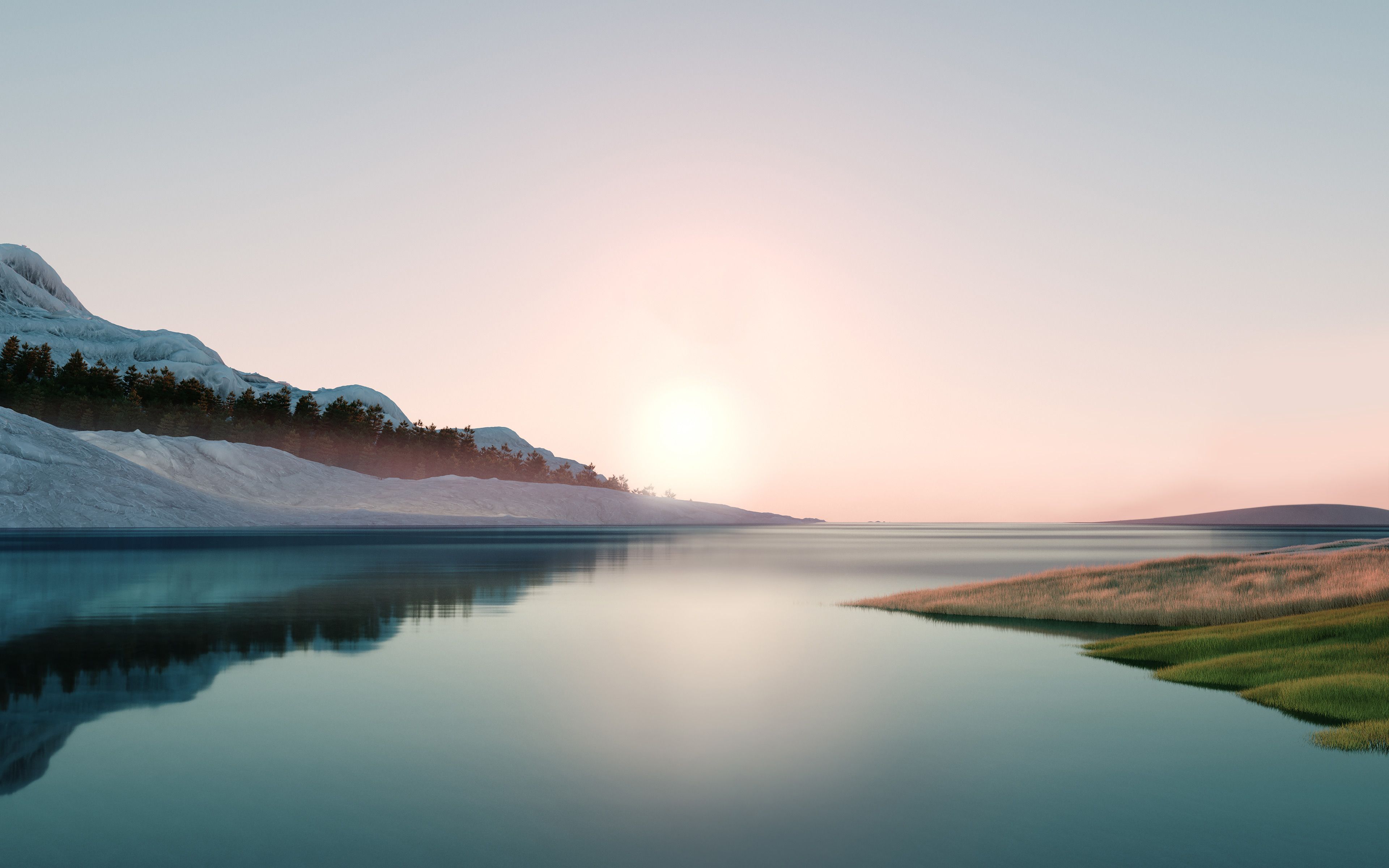 A lake with the sun rising behind the mountains