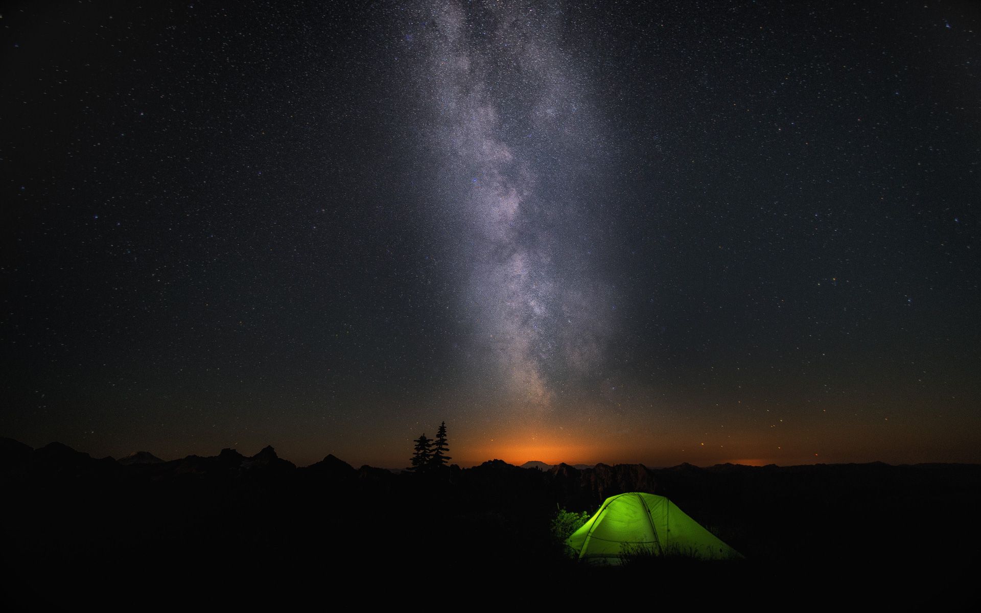 A green tend under a starry night sky