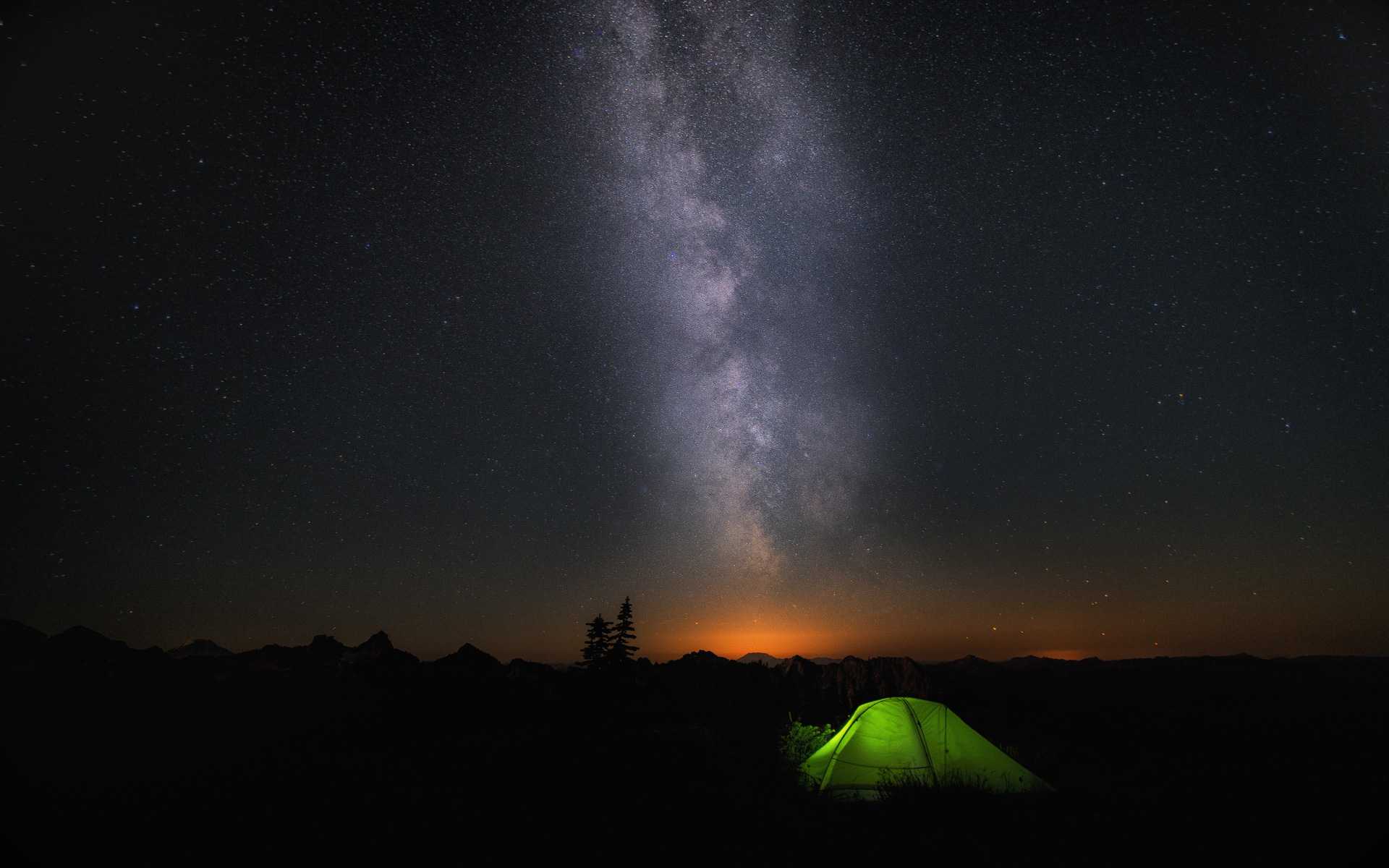 A green tend under a starry night sky
