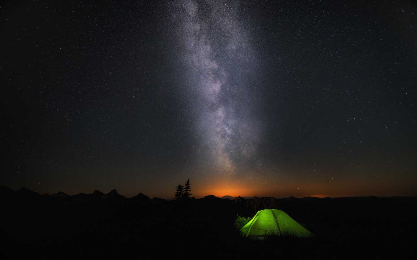 A green tend under a starry night sky