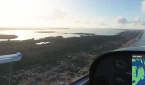 Screenshot from Microsoft Flight Simulator 2020 showing the coast and water reflections